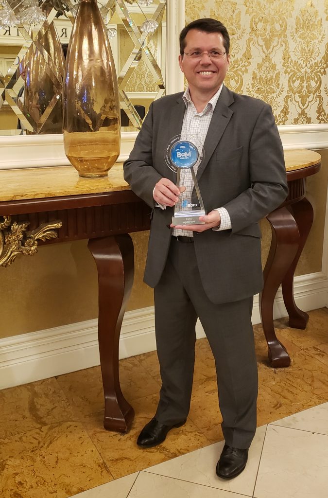 Stuart Newton with OptiQ award